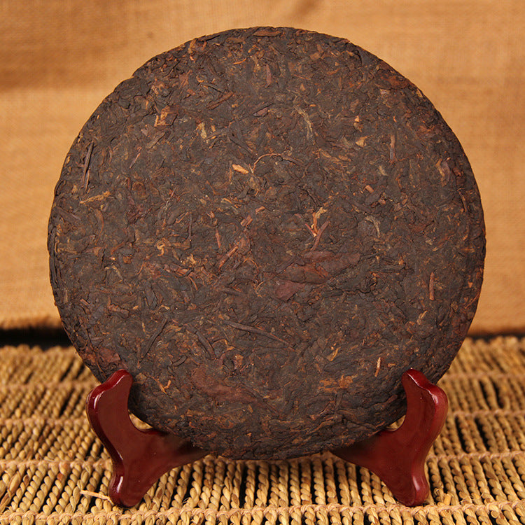 Unwrapped 2009 Eight-Year Aged Rhyme ripe Pu-erh tea cake showing compressed leaf surface