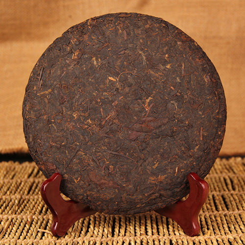 Unwrapped 2009 Eight-Year Aged Rhyme ripe Pu-erh tea cake showing compressed leaf surface