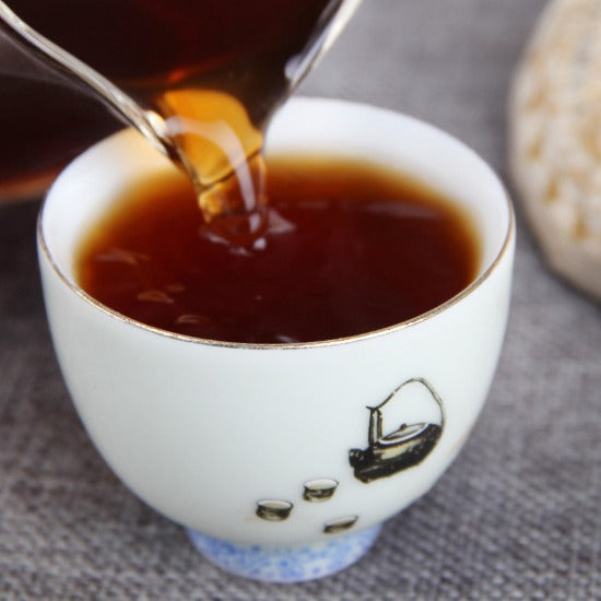 Deep amber tea liquor from 2009 Golden Bud ripe Pu-erh tea cake