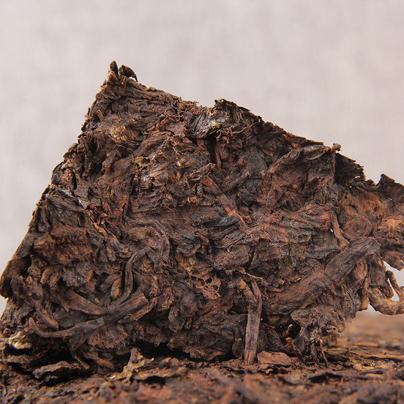 Close-up compressed leaf texture of 2012 Cang Chun Gu Yun ripe Pu-erh brick