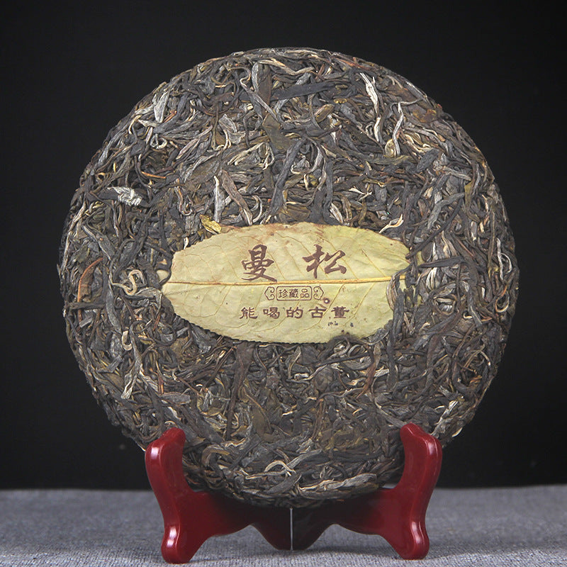 Unwrapped 2016 Mansong raw Pu-erh 357g tea cake showing leaf material