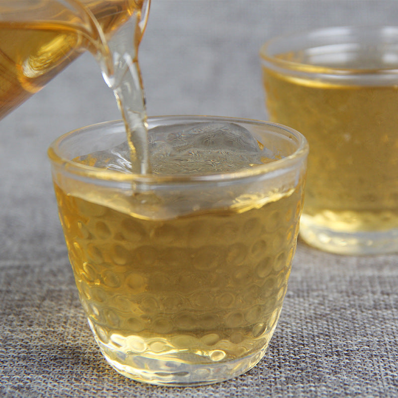 Golden tea liquor brewed from 2017 Xigui-style raw Pu-erh tea cake