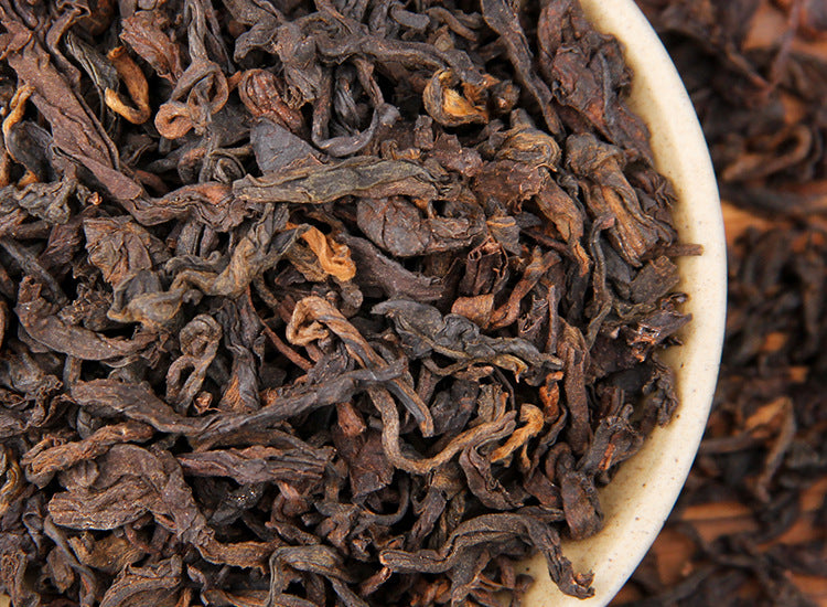 Close-up bowl of six-year aged Bulang Mountain sticky-rice aroma ripe Pu-erh loose tea