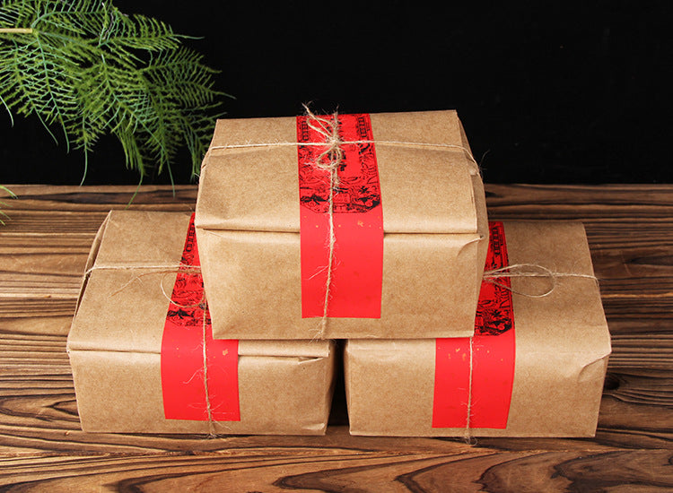 Three kraft-wrapped packs of six-year aged Bulang Mountain sticky-rice aroma ripe Pu-erh