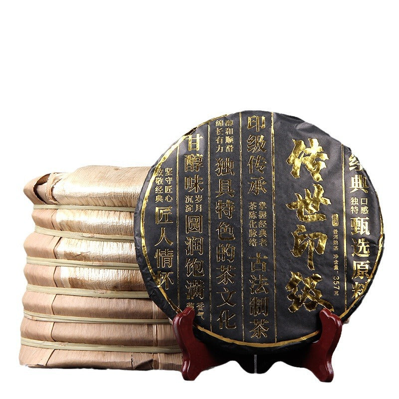 2019 Chuan Shi Yin Ji ripe Pu-erh tea cake displayed with traditional bamboo-wrapped stack