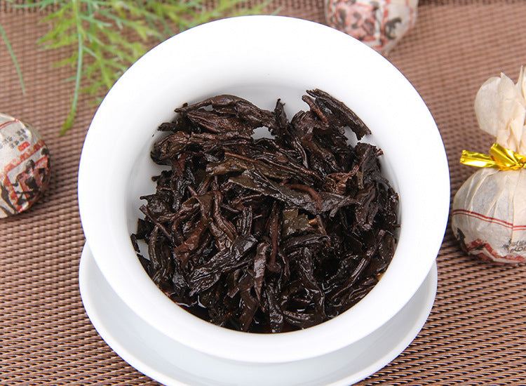 Jingmai ripe Pu-erh tea pearl wrapper and tea detail