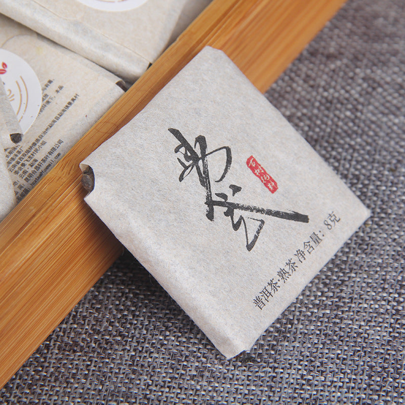 2022 Yiwu ripe Pu-erh mini squares arranged in bamboo tea tray