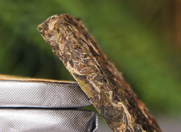 Close-up side view of 2023 Bingdao Silver Brick raw Pu-erh mini square tea