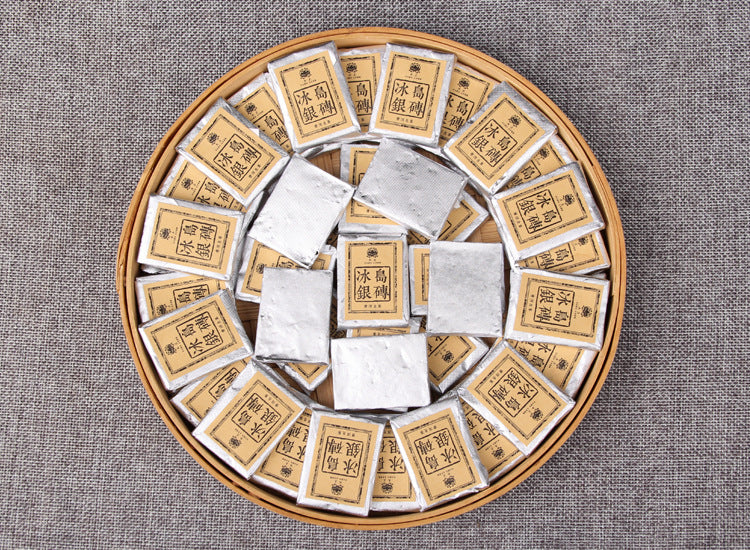 2023 Bingdao raw Pu-erh mini silver bricks arranged on a tea tray