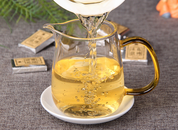 Golden 2023 Bingdao raw Pu-erh tea liquor in glass fairness pitcher