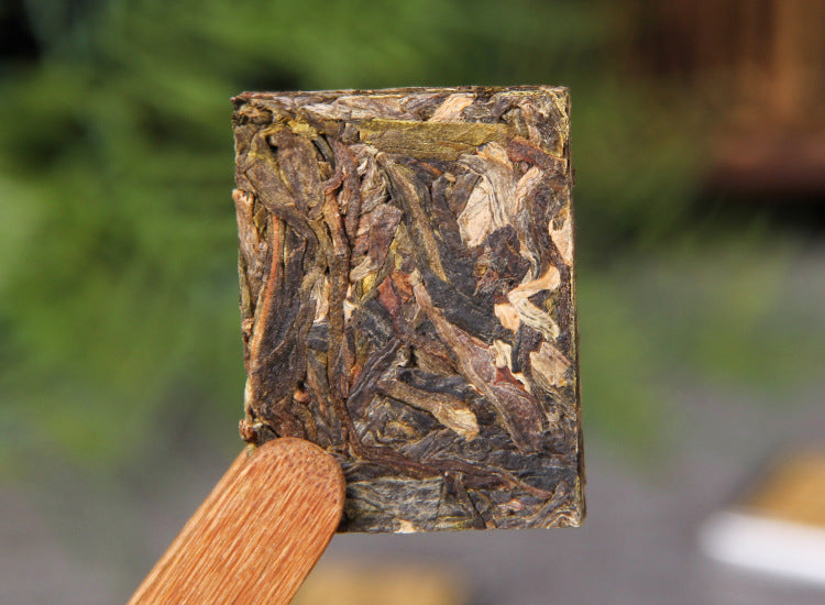 Front view of unwrapped 2023 Bingdao raw Pu-erh mini square tea
