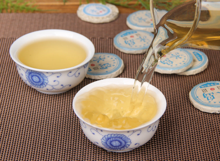2023 Bingdao sweet raw Pu-erh mini cake with blue wrapper and compressed leaf detail