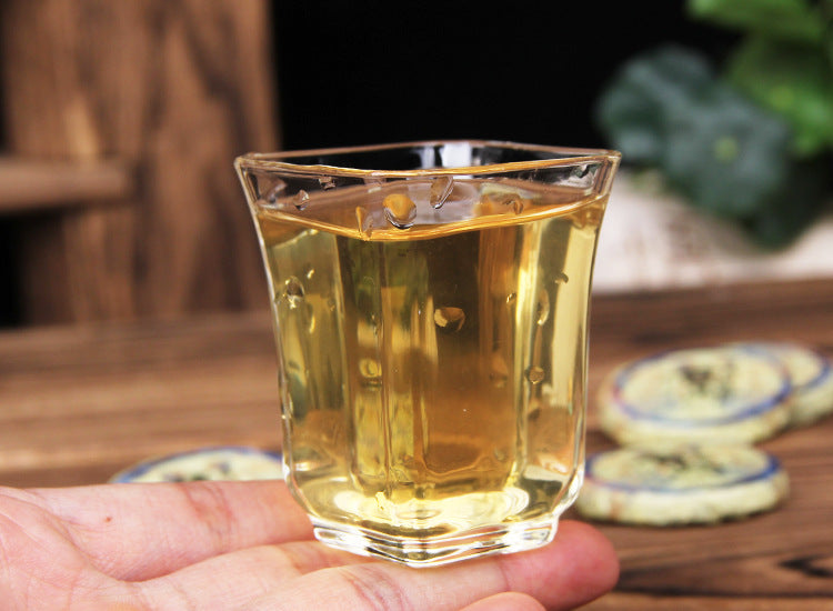 Clear golden liquor brewed from 2023 Xigui raw Pu-erh mini tea cake