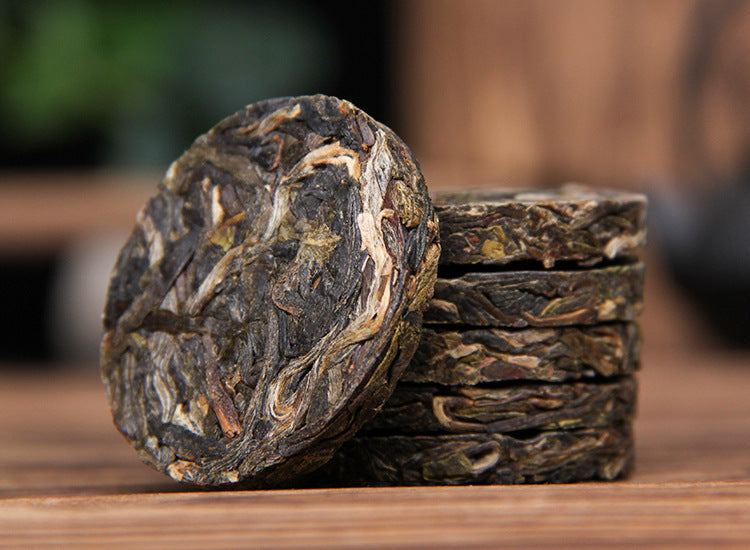 Unwrapped 2023 Xigui raw Pu-erh mini tea cakes stacked compressed sheng puer