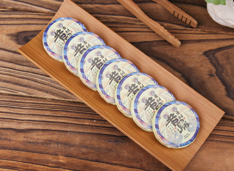 Row of individually wrapped 2023 Xigui raw Pu-erh mini tea cakes 6g each