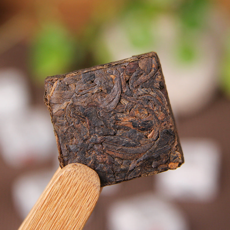 Unwrapped camphor aroma ripe Pu-erh mini square brick close-up