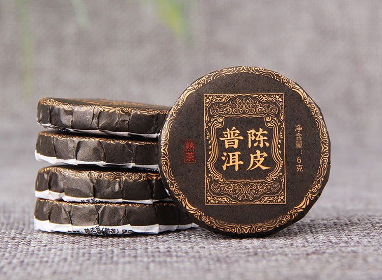 Deep red liquor brewed from Chenpi ripe Pu-erh mini cake