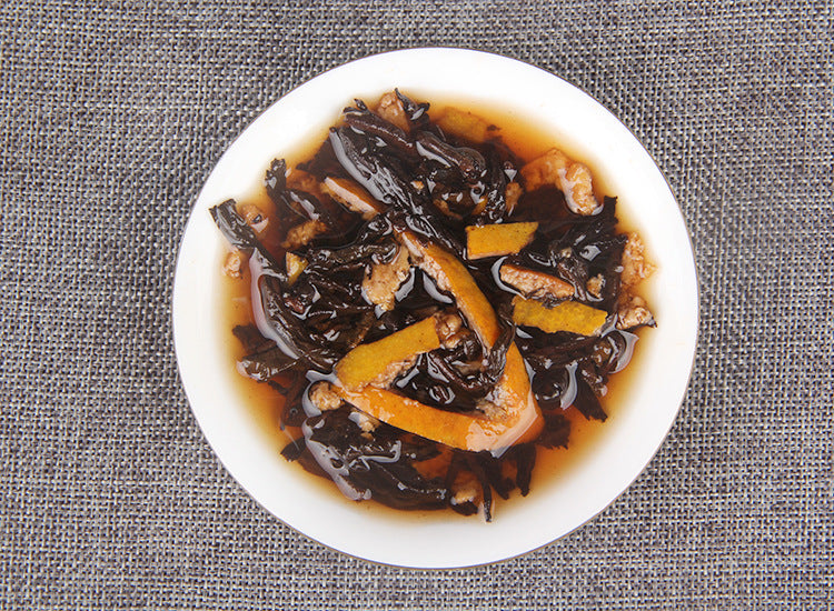 Chenpi ripe Pu-erh mini tea cakes in bamboo tray