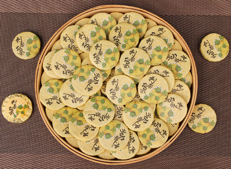 Tray of individually wrapped Cili chestnut rose Yunnan black tea mini cakes
