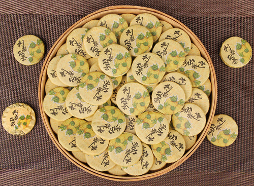 Tray of individually wrapped Cili chestnut rose Yunnan black tea mini cakes