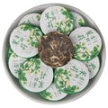 2025 jasmine aroma raw Pu-erh mini tea cakes 500g displayed wrapped with one unwrapped cake
