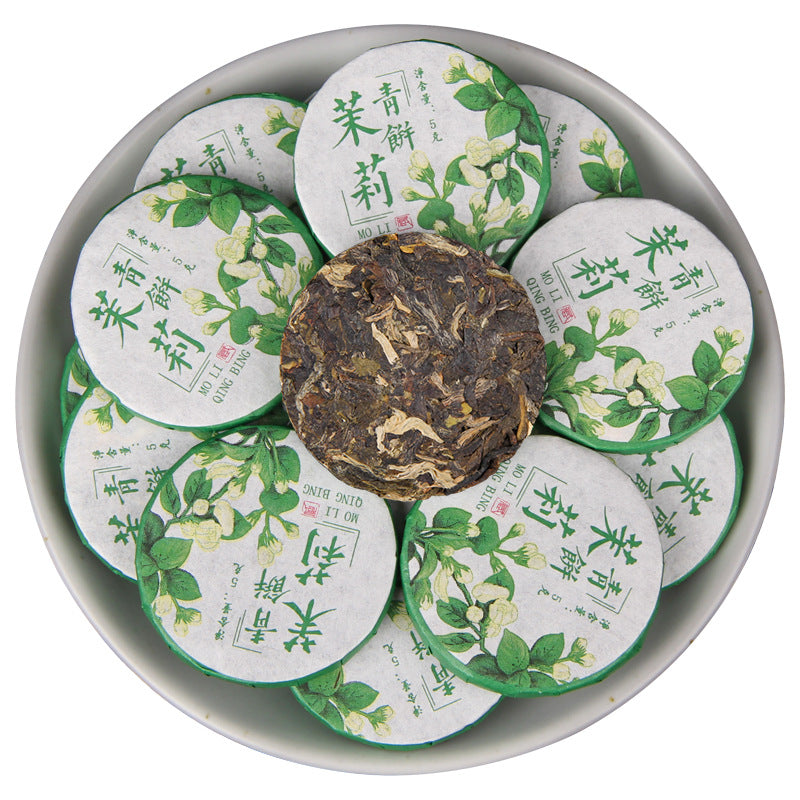 2025 jasmine aroma raw Pu-erh mini tea cakes 500g displayed wrapped with one unwrapped cake