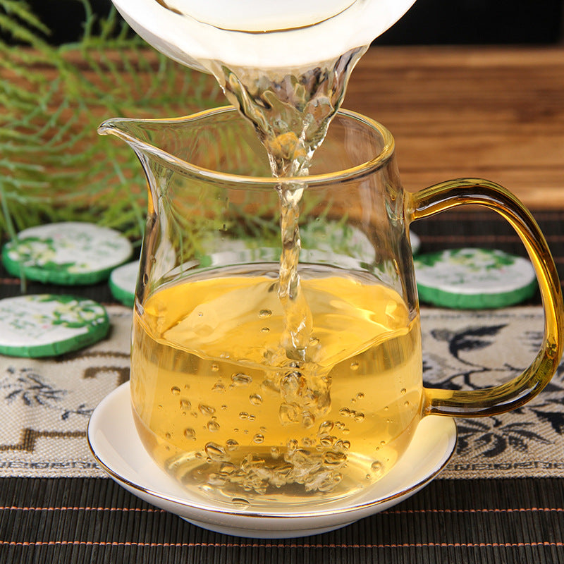 Golden tea liquor brewed from 2025 jasmine aroma raw Pu-erh mini tea cakes