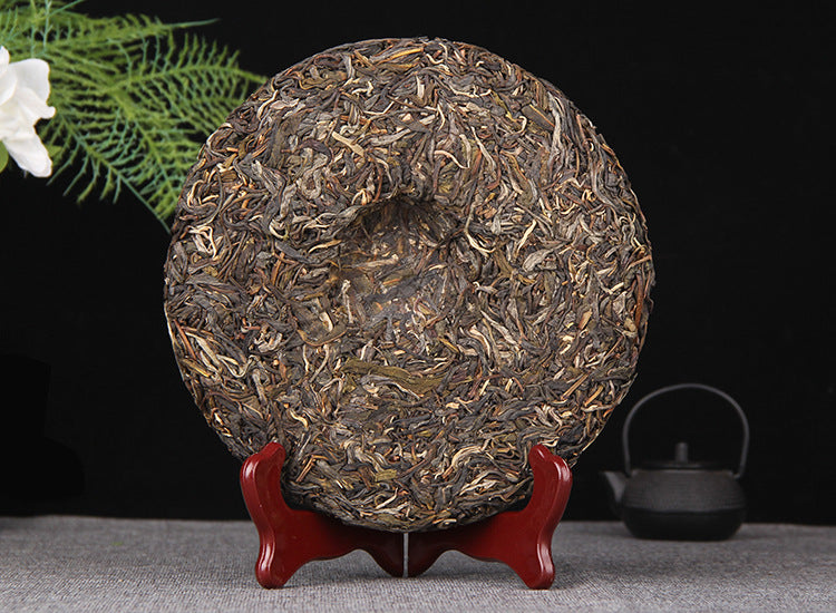 Unwrapped 2025 Mangfei raw Pu-erh 357g tea cake on display stand