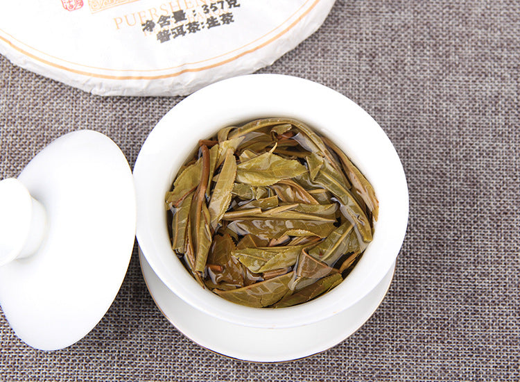 Infused leaves from 2025 Mangfei raw Pu-erh tea in a porcelain gaiwan