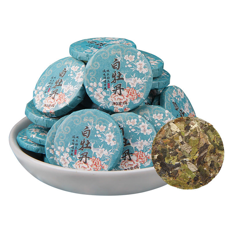 2025 Yunnan Bai Mudan white tea mini cakes displayed wrapped and unwrapped