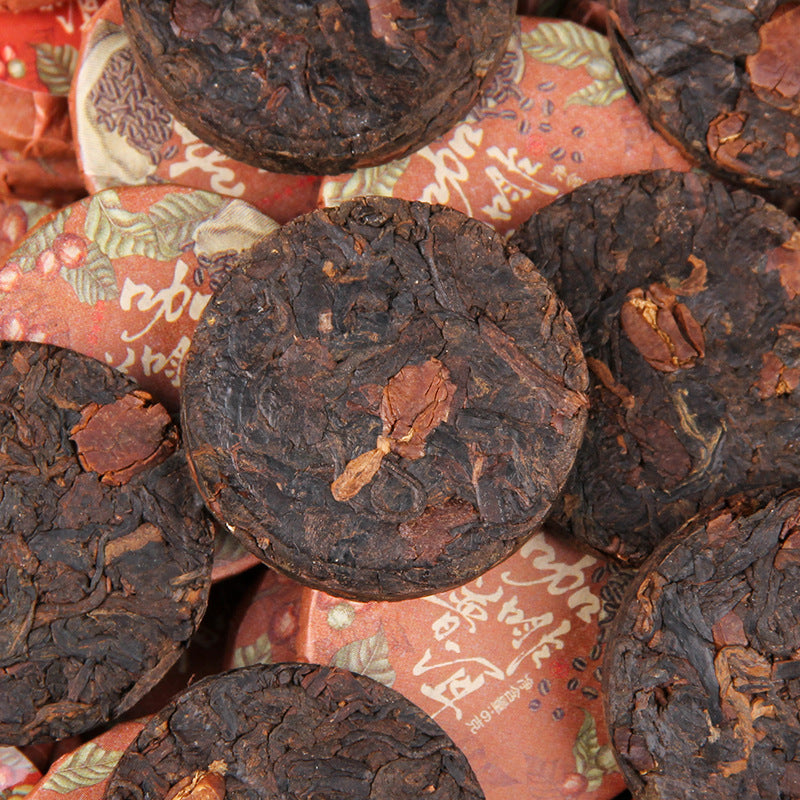Unwrapped 2025 Yunnan coffee aroma ripe Pu-erh mini tea cakes showing compressed tea