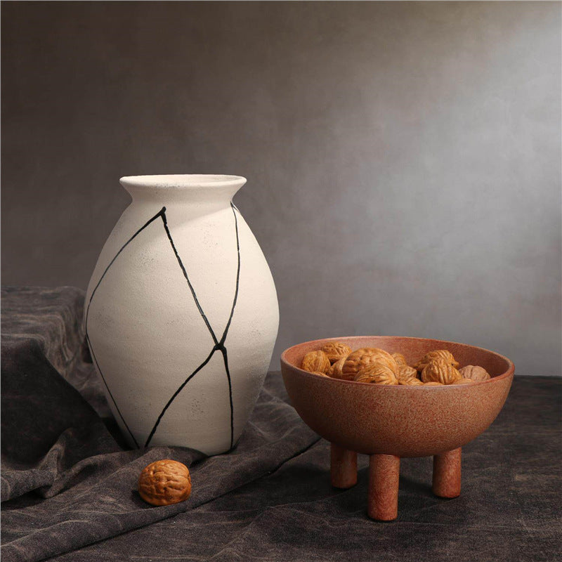 Contemporary artisan ceramic vase collection with white diamond vessel and terracotta tripod bowl