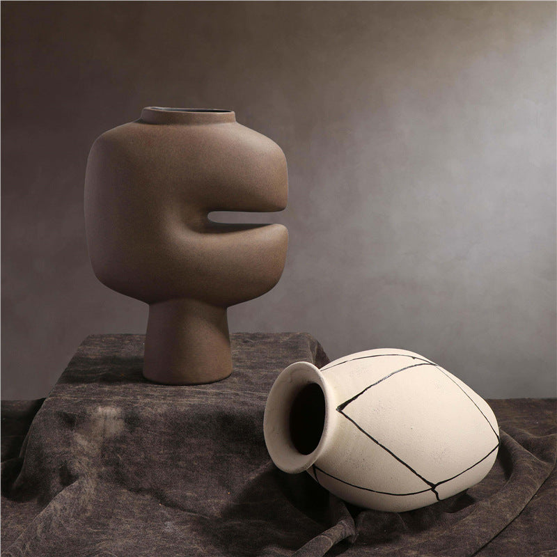 Sculptural brown cutout and white diamond ceramic vases styled together