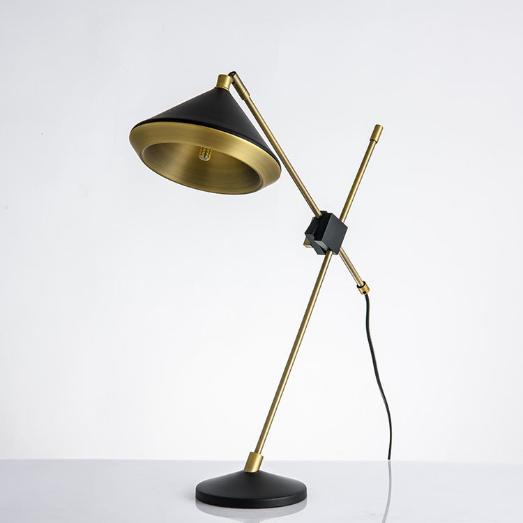 Black cone-shade and antique-brass adjustable table lamp, angled view