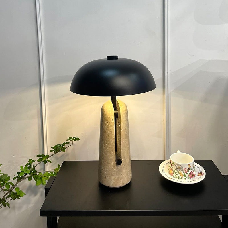 Yellow travertine mushroom table lamp styled on a dark side table with tea set