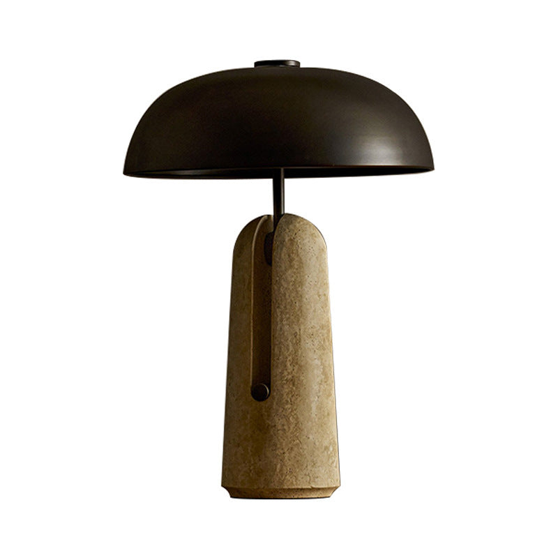 Sculptural black dome table lamp with yellow travertine stone base on white background