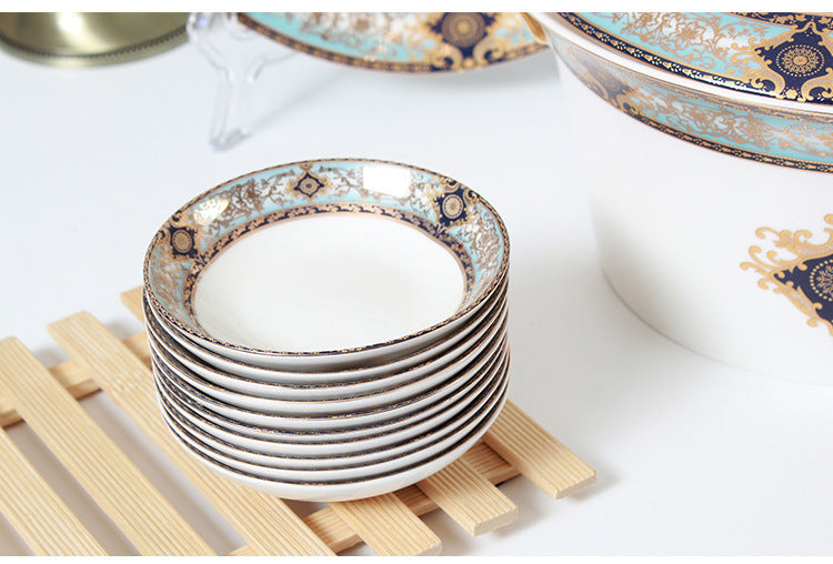Stacked Bibo porcelain seasoning dishes with ornate turquoise navy and gold rim pattern