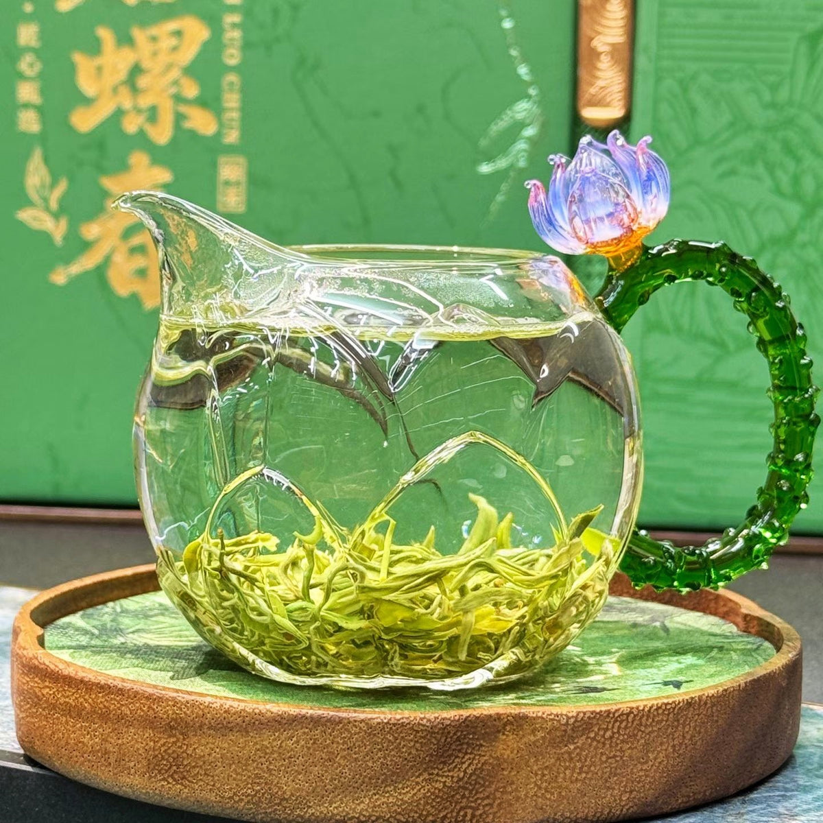 Bi Luo Chun curled green tea leaves opening in clear glass pitcher