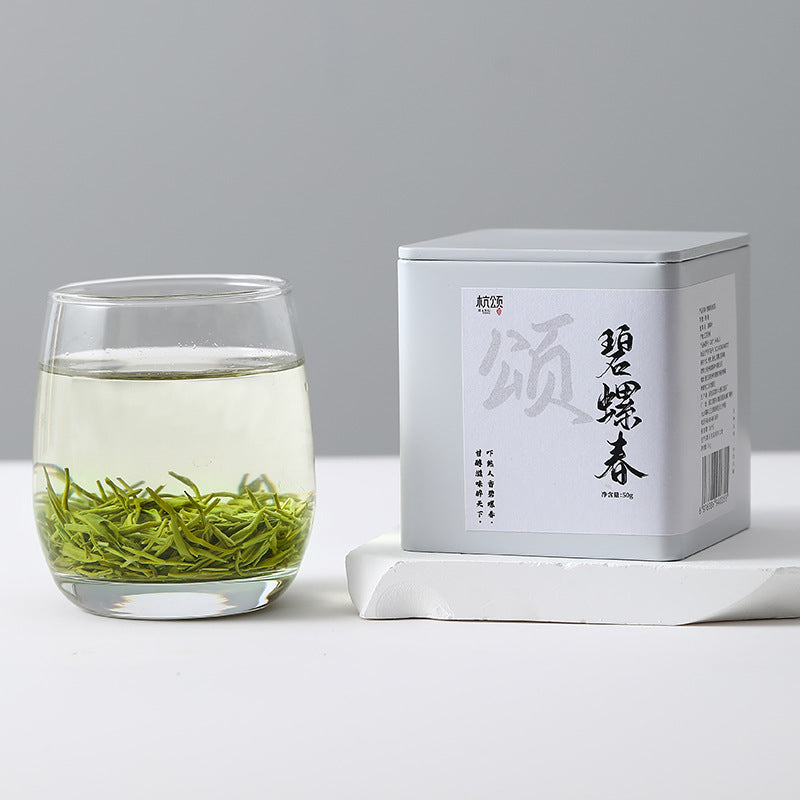Pale yellow-green Bi Luo Chun tea liquor and curled leaves