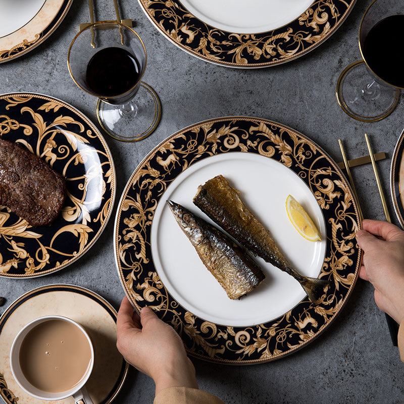 Luxury black and gold bone china dinner plates styled with wine glasses for an elegant table setting