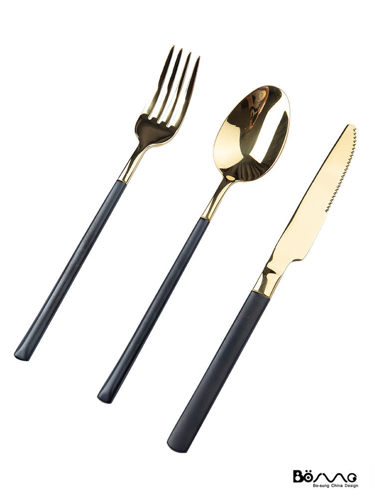 Three-piece black-handle gold flatware set with knife, fork and spoon