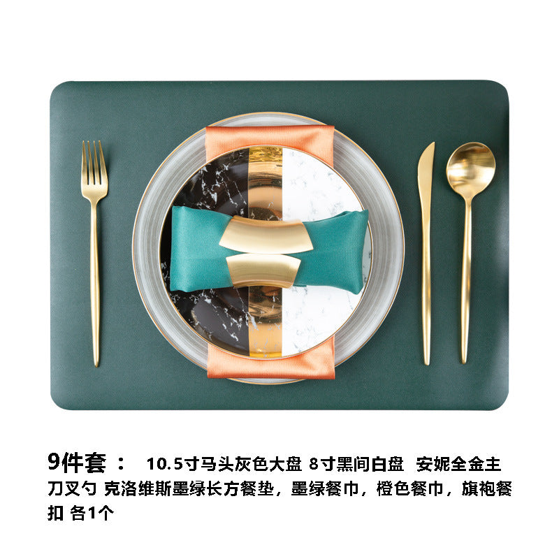 Luxury black white marble pattern bone china tableware styled with gold cutlery and emerald green napkin