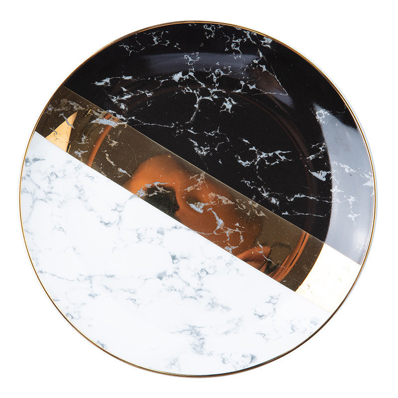 Modern marble-look bone china dinnerware with grey plate, black and white accent plate and gold flatware