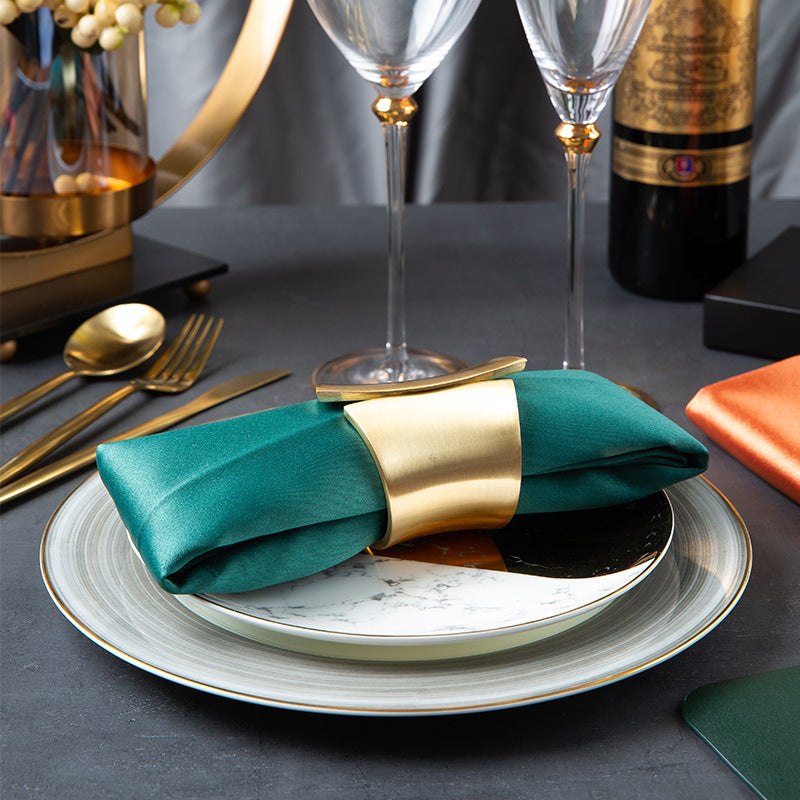 Black and white marble accent plate with warm metallic stripe for modern luxury table settings