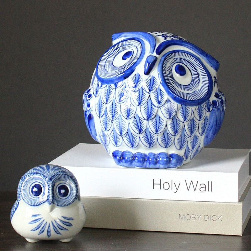 Blue and white ceramic owl figurines styled on books