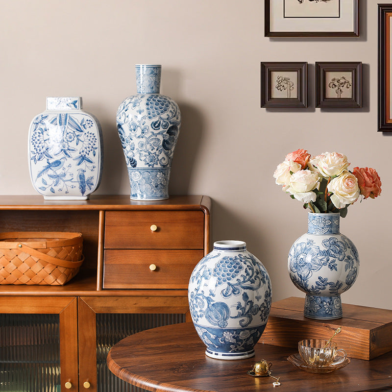 Blue and white Chinese ceramic vase collection on a wood console