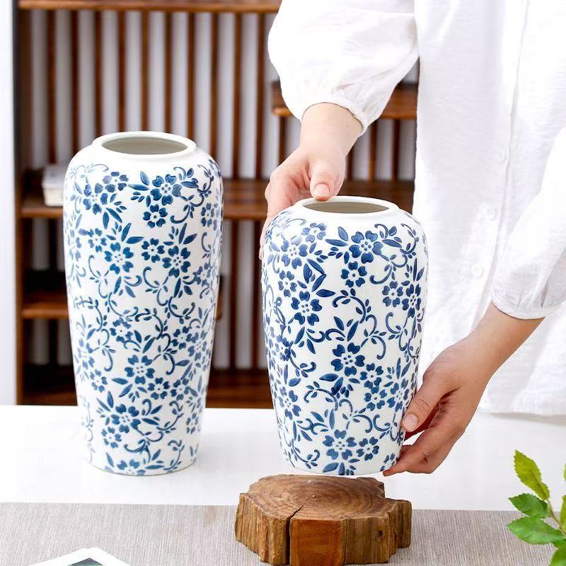 Blue and white floral cylinder vases shown together for scale