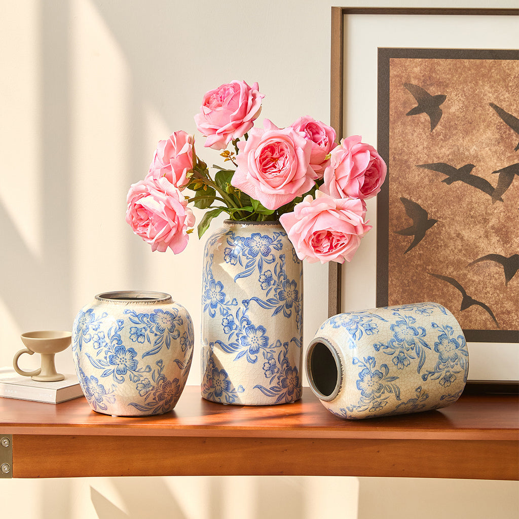 Blue and white decorative vase collection on a wood console