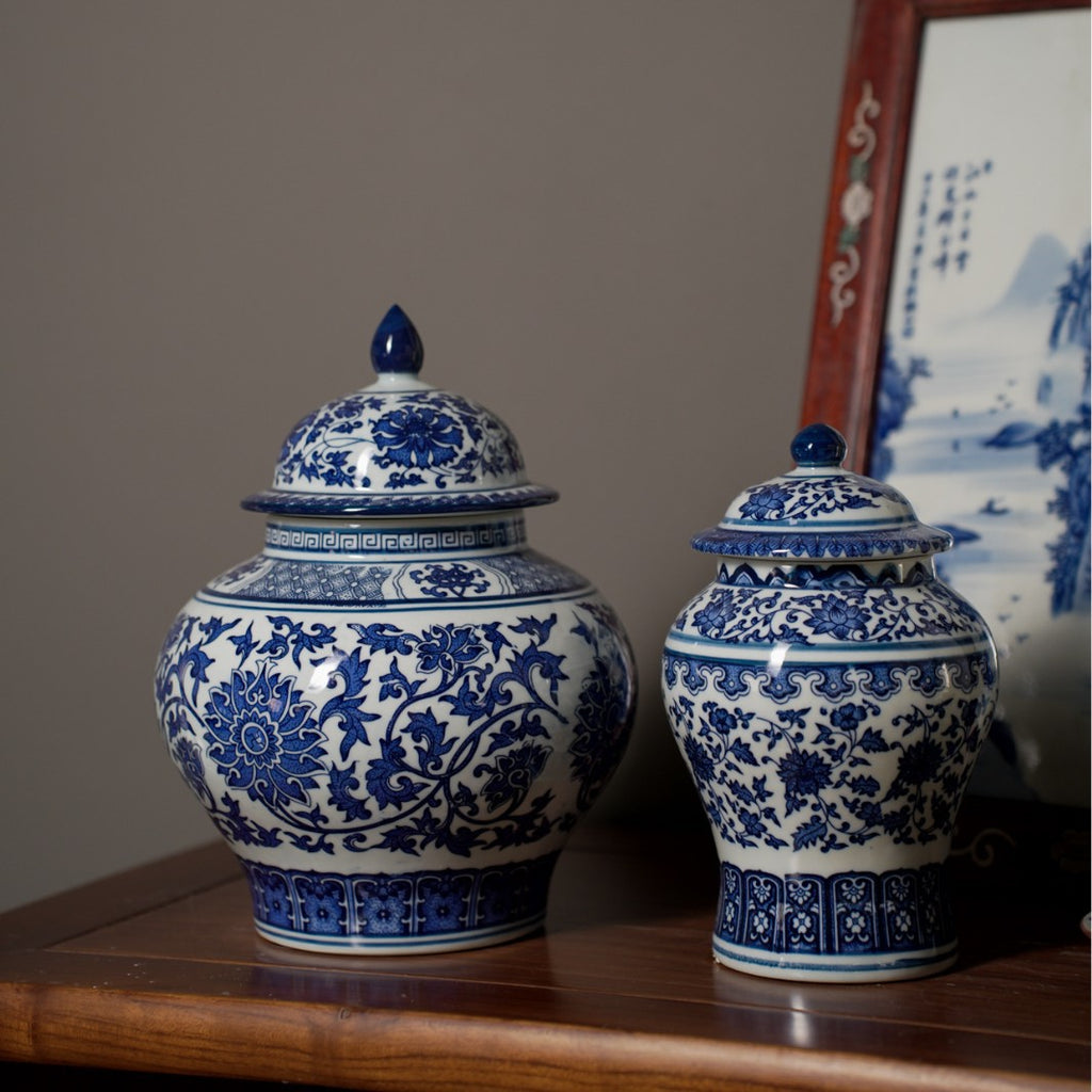 Blue and white lidded jars styled together on dark wood