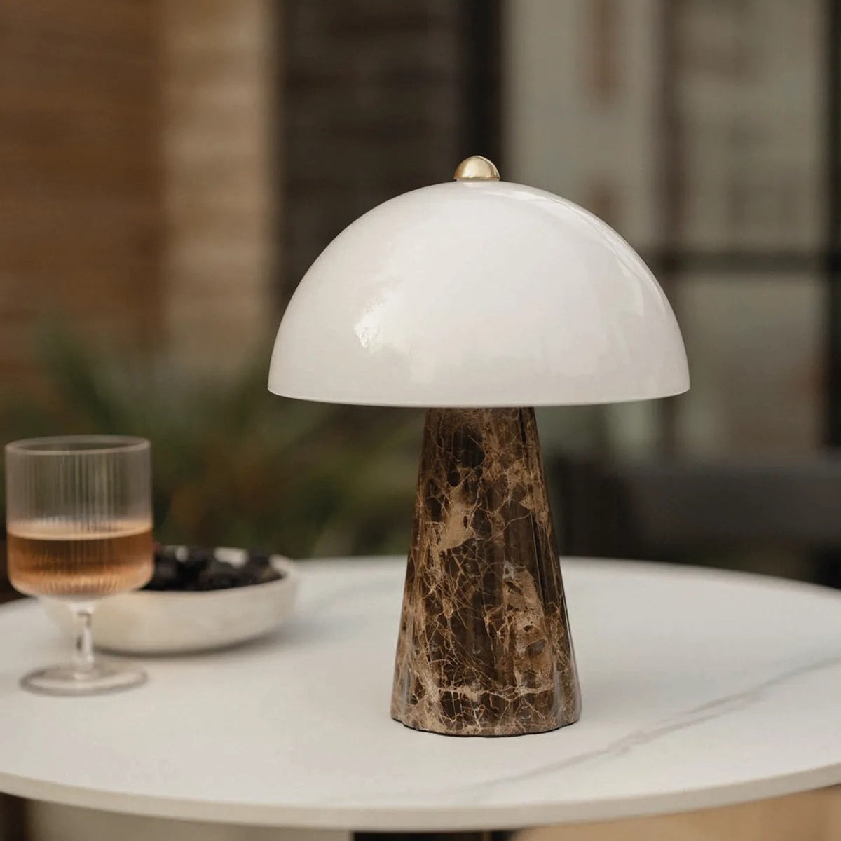 Flared brown marble mushroom table lamp styled on a dining table